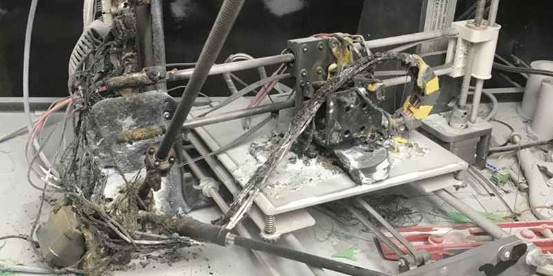 A 3D printer fire hazard that was set on fire and burned.