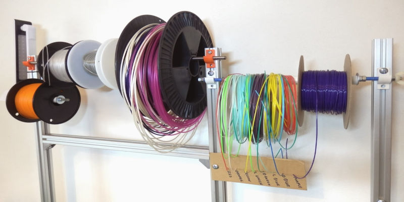 A range of filaments stored on a rack